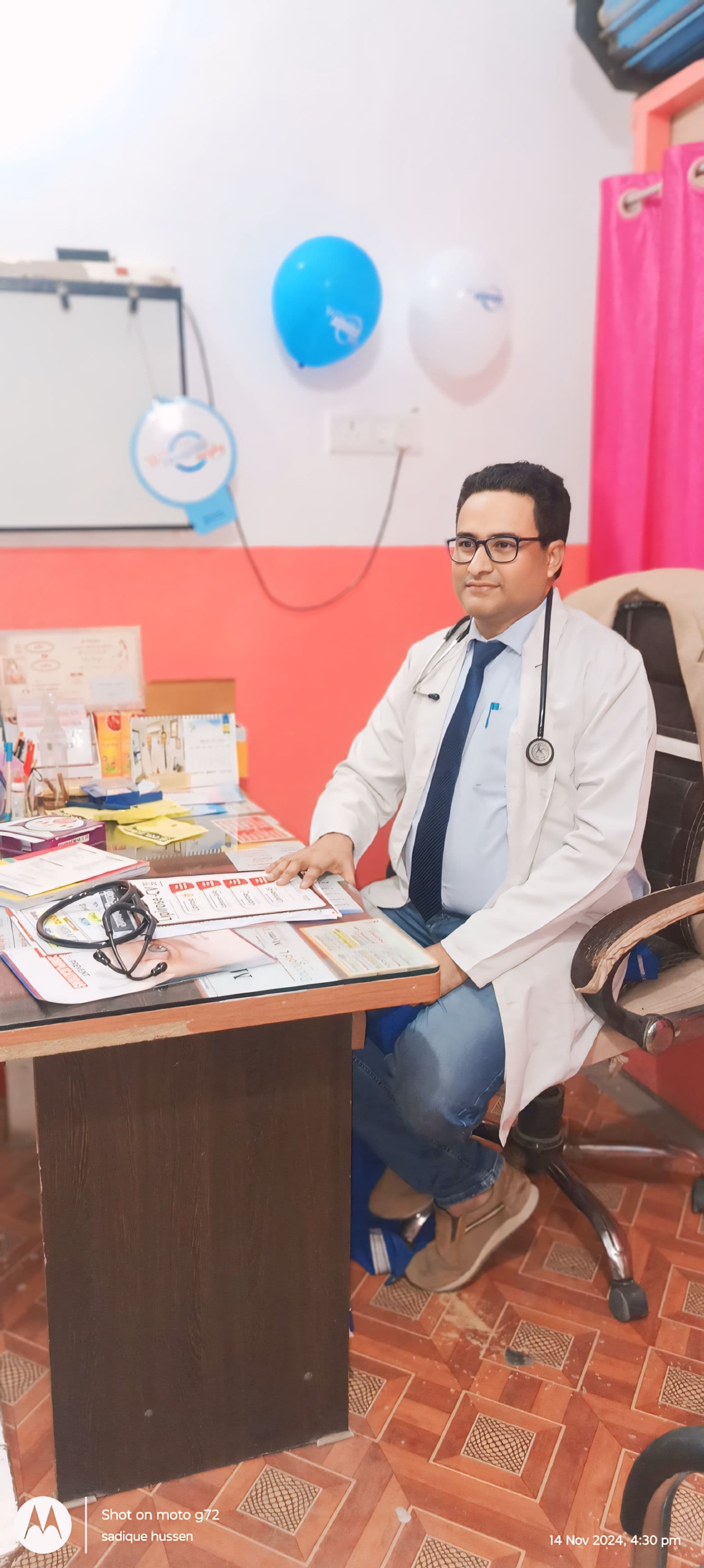Dr. S. Hussain reviewing patient records at Siwan clinic consultation desk Dr. S. Hussain, physician and diabetologist in Siwan, at his clinic consultation desk reviewing patient records