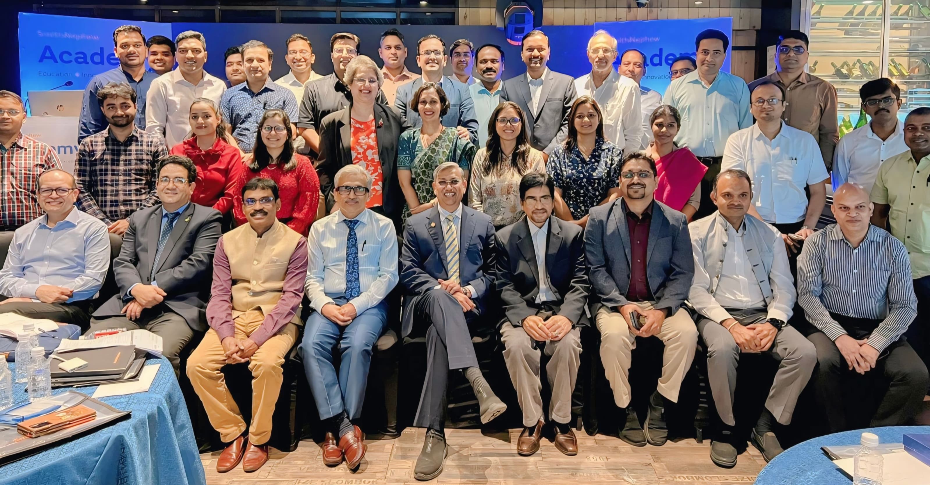 Dr. S. Hussain with peers at CME medical conference — vertical portrait Vertical group portrait of Dr. S. Hussain with peers at a medical education CME conference